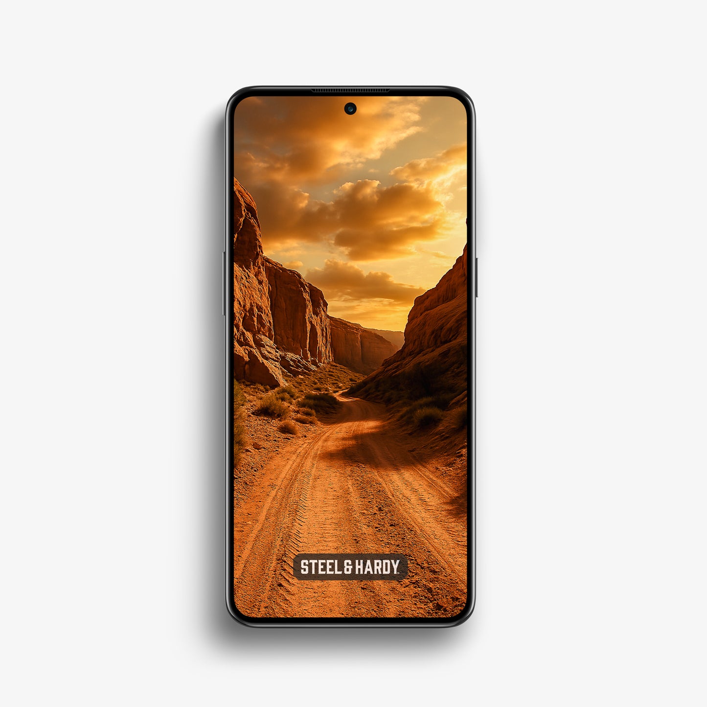 Steel & Hardy mobile wallpaper featuring a remote desert trail winding through sandstone cliffs at sunset