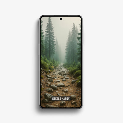 Steel & Hardy mobile wallpaper of a rocky alpine trail through tall pine trees, surrounded by morning mist