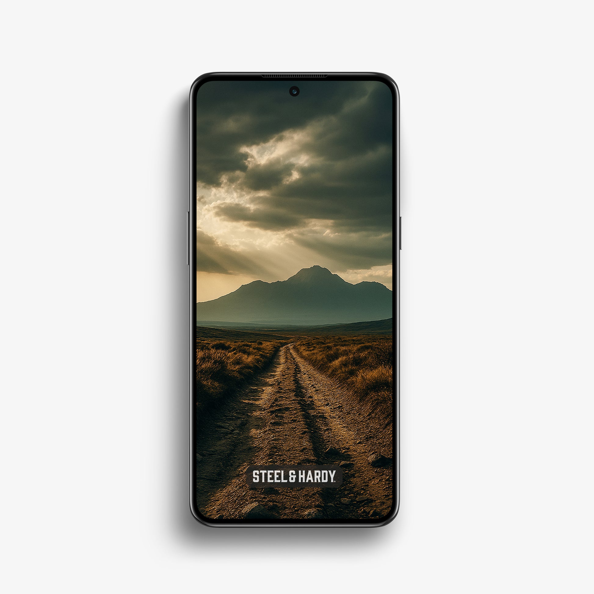 Steel & Hardy mobile wallpaper showing a rugged off-road track with deep ruts and mountain silhouette beneath a stormy sky